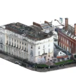 Colourised point cloud of a stone-fronted historic building, a brick neighbour and a courtyard with a curved glass canopy